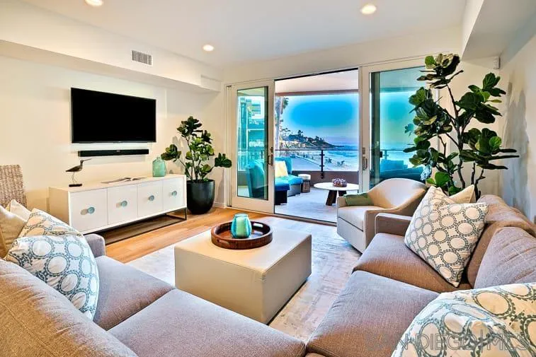 6767 Neptune Place, Unit 202 La Jolla, CA 92037 - Photo 4 of 27 a living room with furniture potted plant and a flat screen tv