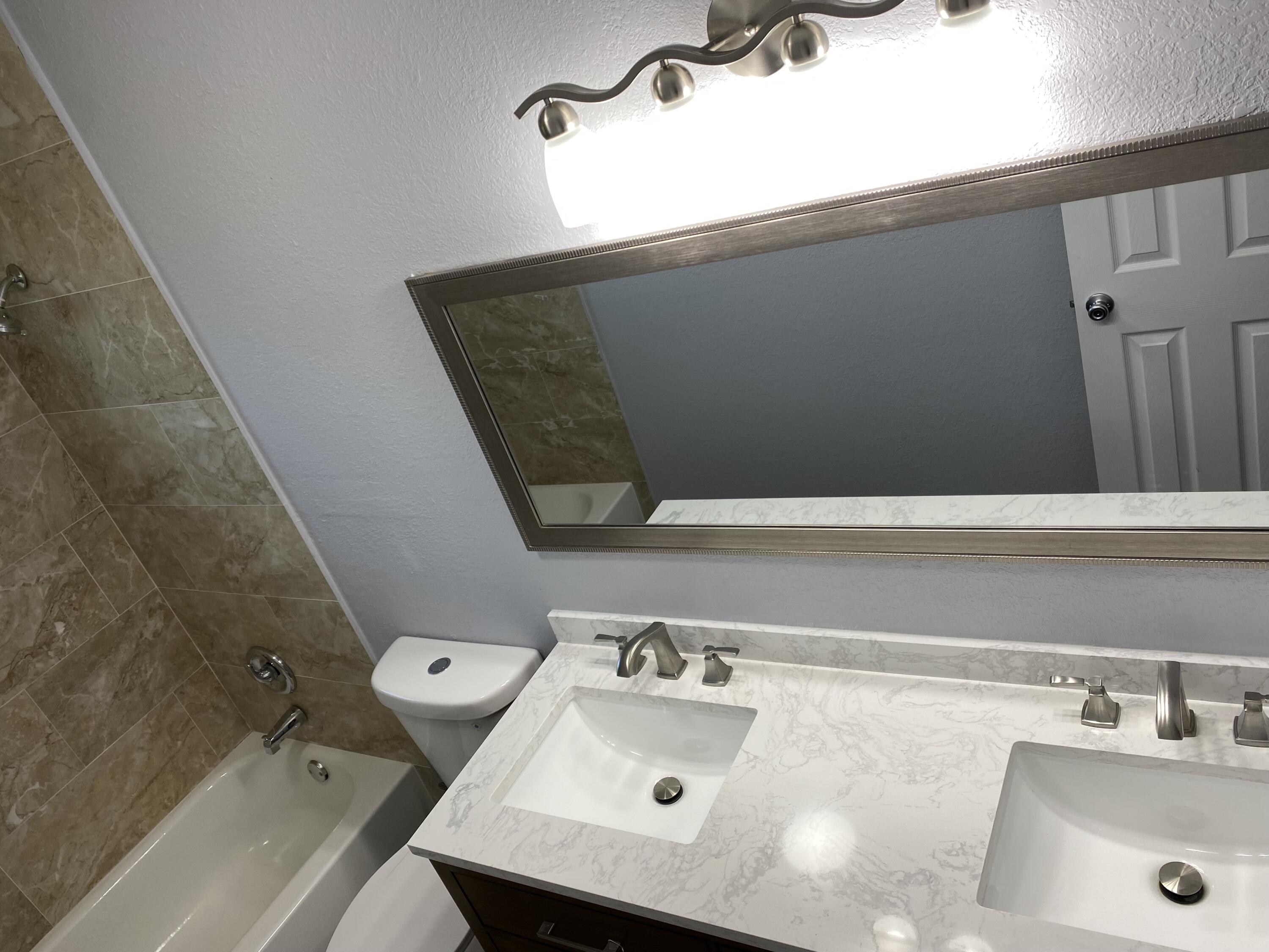 232 Northwest 9th Street Pompano Beach, FL 33060 - Photo 13 of 46 a bathroom with a sink and a toilet