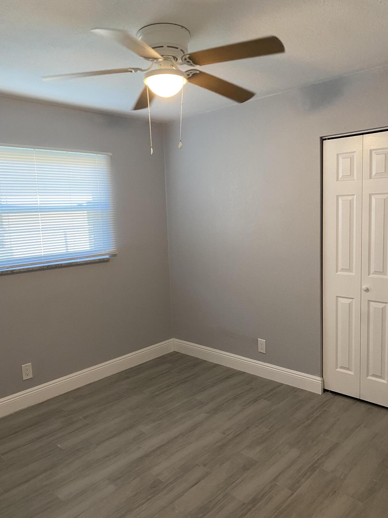 232 Northwest 9th Street Pompano Beach, FL 33060 - Photo 14 of 46 a view of a room with wooden floor and fan
