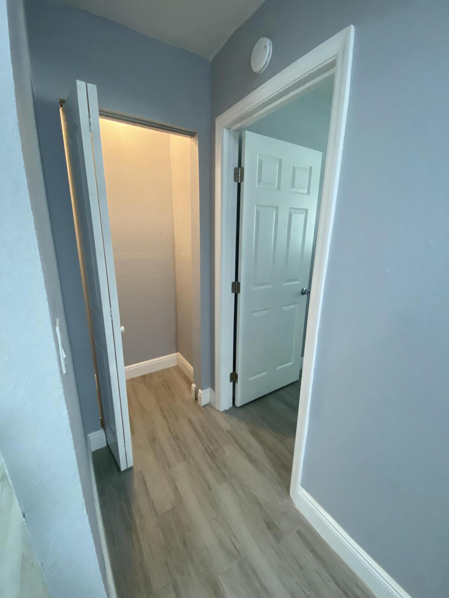232 Northwest 9th Street Pompano Beach, FL 33060 - Photo 16 of 46 an empty room with wooden floor and a door