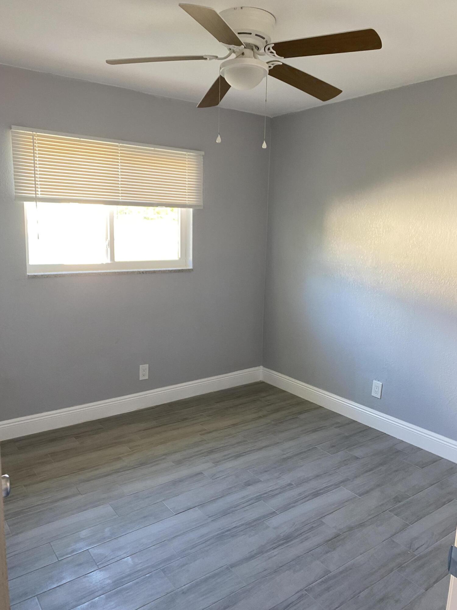232 Northwest 9th Street Pompano Beach, FL 33060 - Photo 17 of 46 wooden floor in an empty room with a window