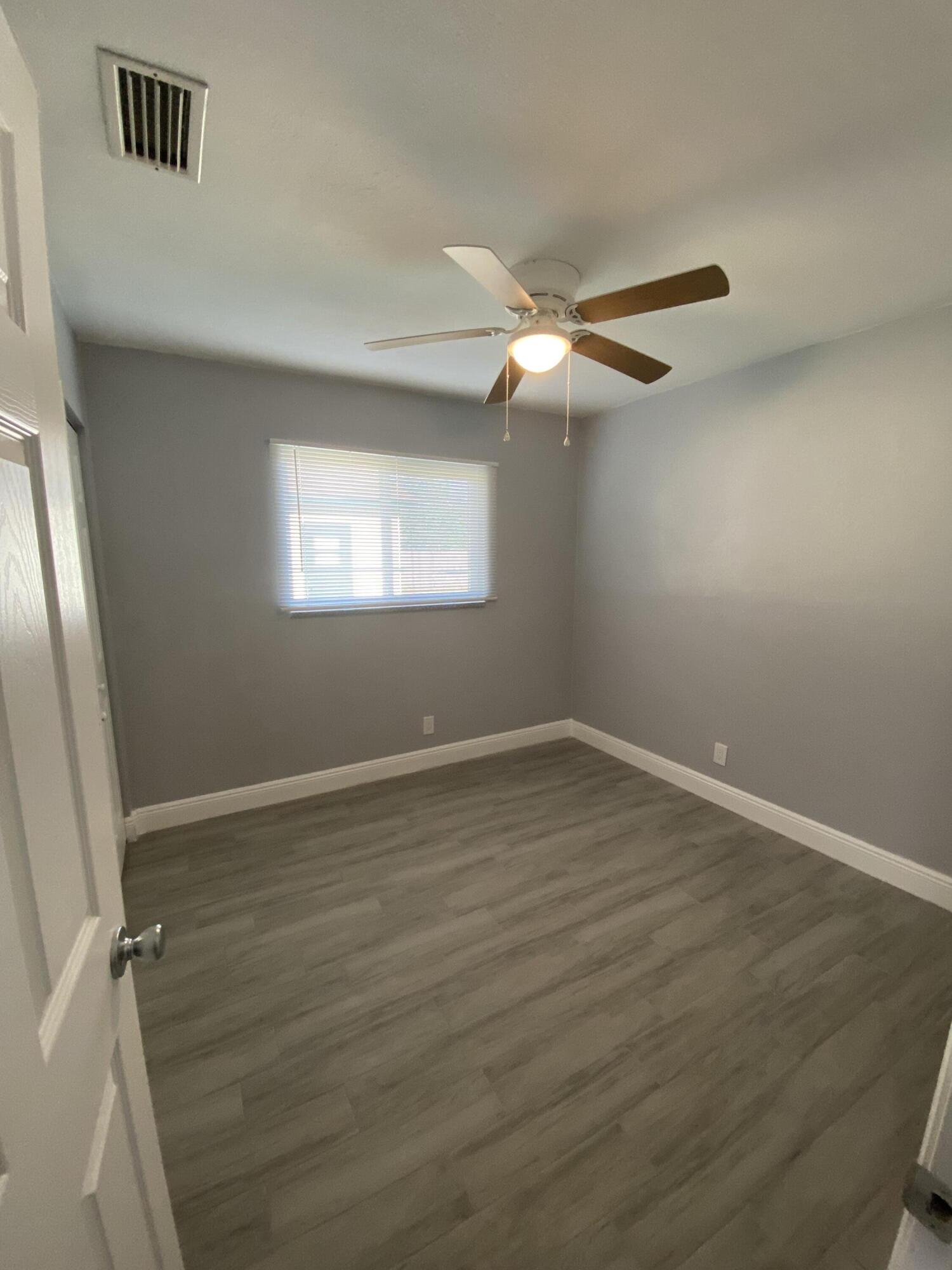 232 Northwest 9th Street Pompano Beach, FL 33060 - Photo 18 of 46 wooden floor in an empty room with a window