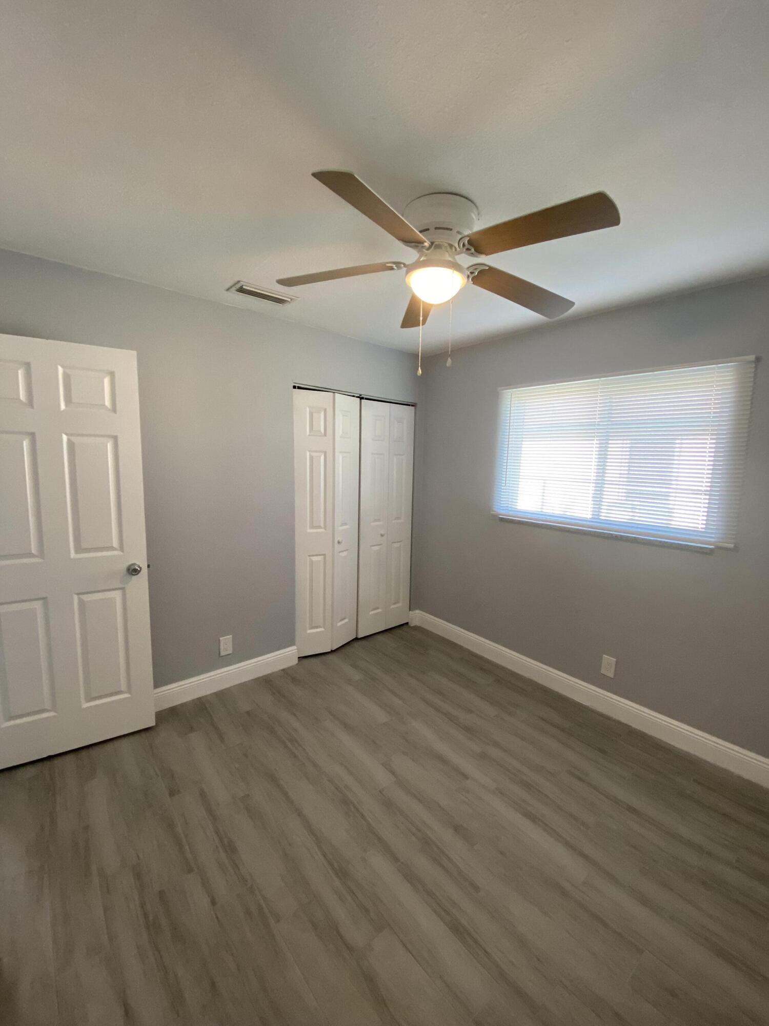 232 Northwest 9th Street Pompano Beach, FL 33060 - Photo 19 of 46 a view of an empty room with wooden floor and a window