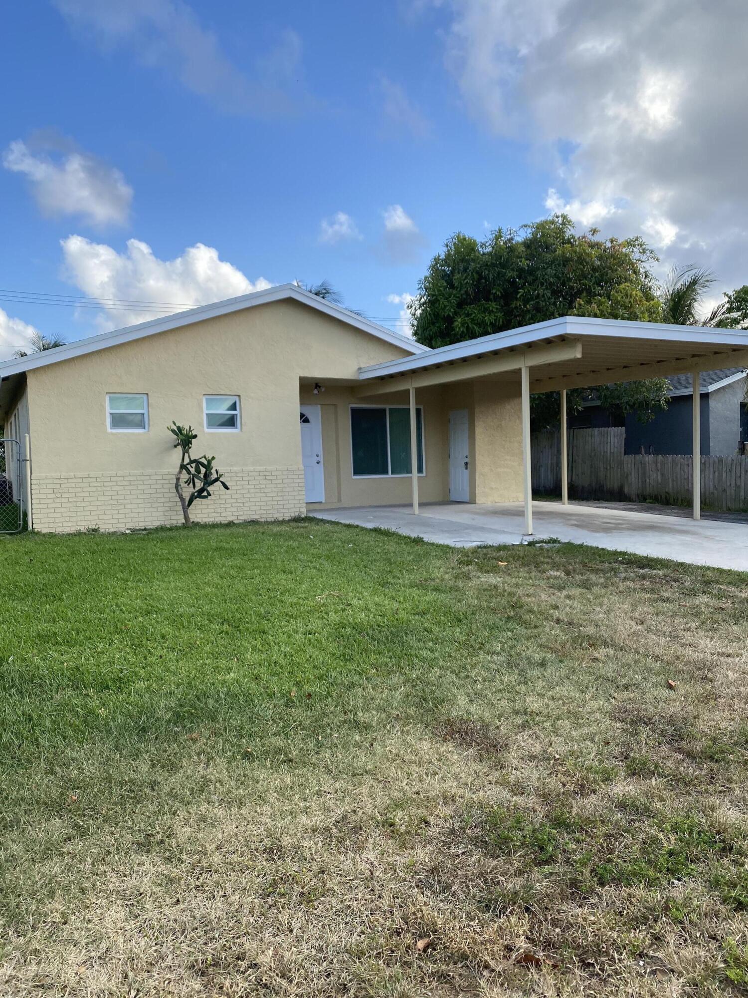 232 Northwest 9th Street Pompano Beach, FL 33060 - Photo 2 of 46 a backyard of a house with lots of green space