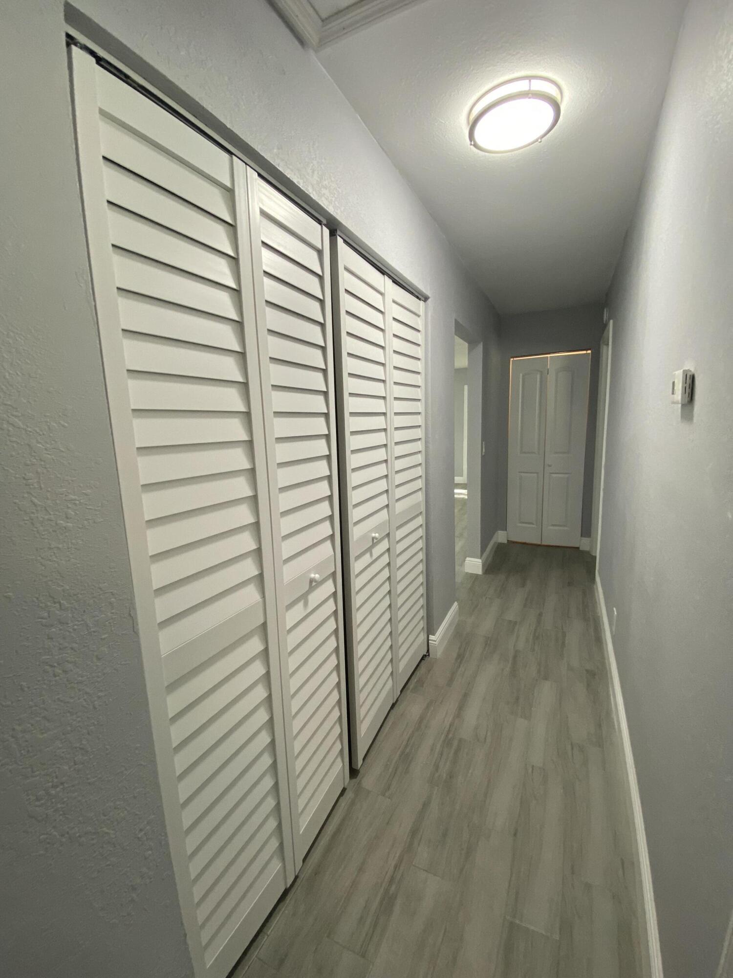 232 Northwest 9th Street Pompano Beach, FL 33060 - Photo 23 of 46 a view of a hallway with wooden floor and staircase