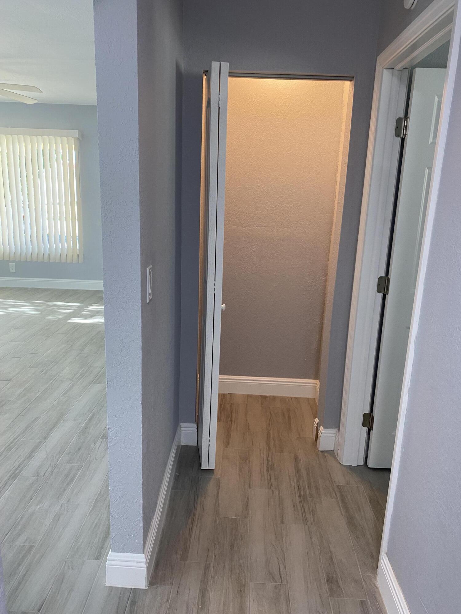 232 Northwest 9th Street Pompano Beach, FL 33060 - Photo 24 of 46 an empty room with wooden floor and windows