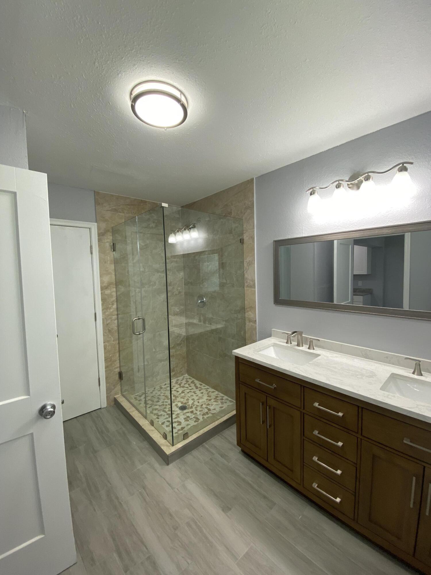 232 Northwest 9th Street Pompano Beach, FL 33060 - Photo 27 of 46 a bathroom with a double vanity sink mirror and double
