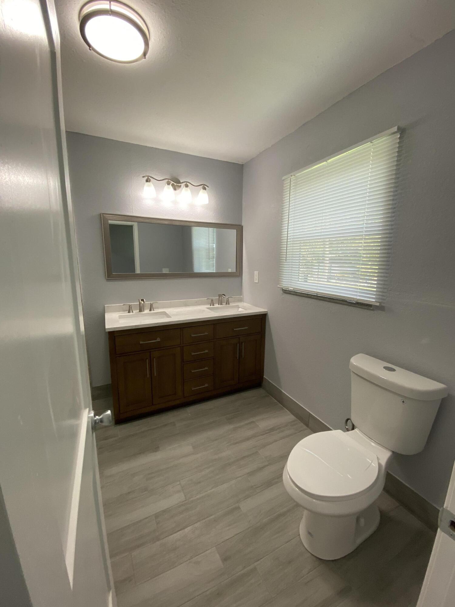 232 Northwest 9th Street Pompano Beach, FL 33060 - Photo 28 of 46 a bathroom with a sink a toilet and mirror