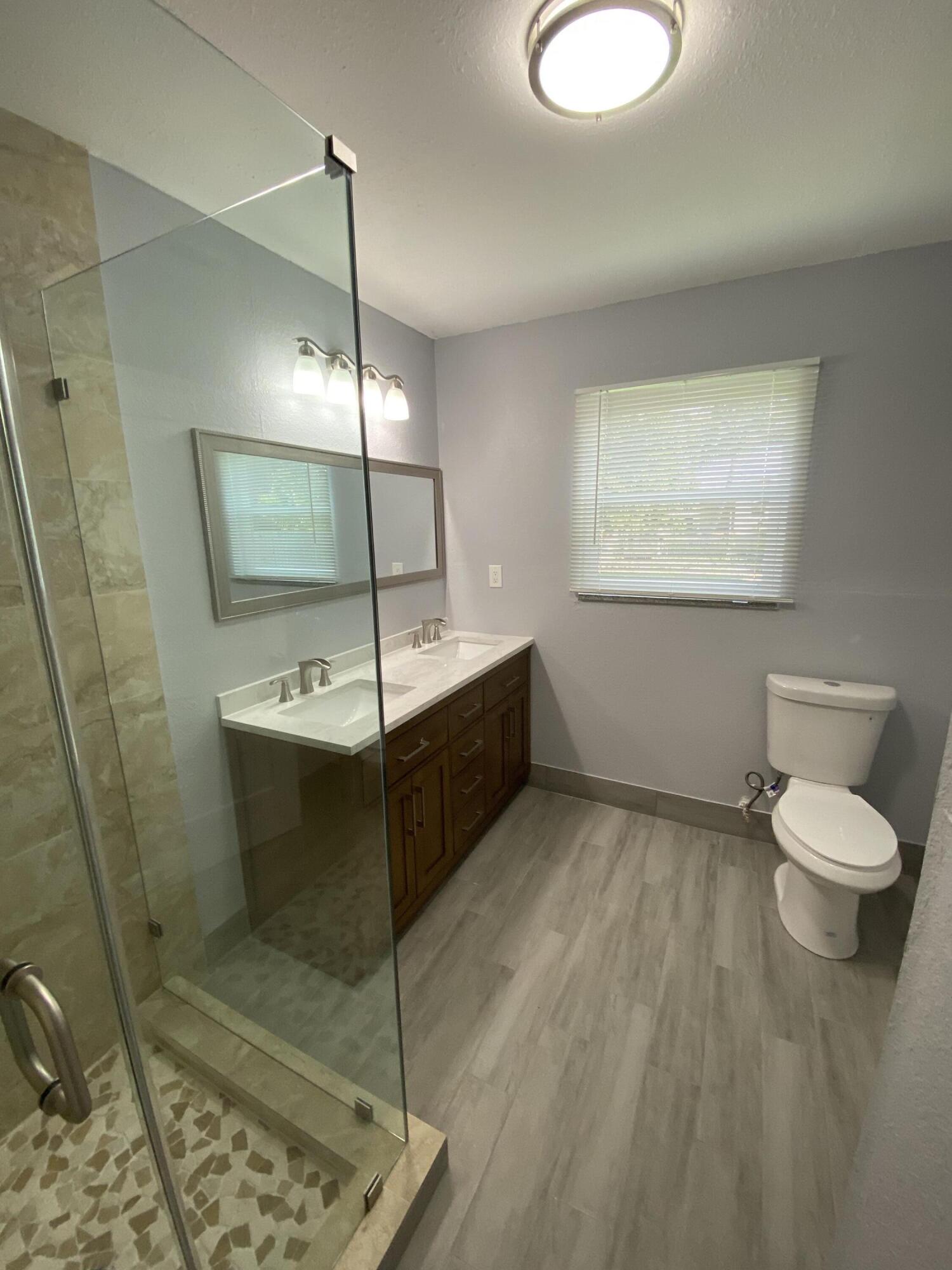 232 Northwest 9th Street Pompano Beach, FL 33060 - Photo 29 of 46 a bathroom with a sink toilet and mirror