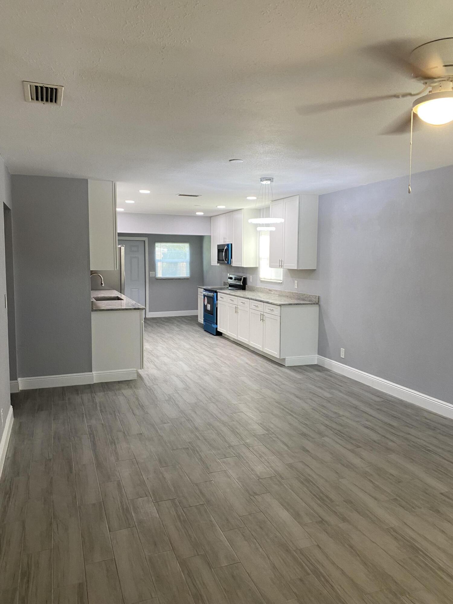 232 Northwest 9th Street Pompano Beach, FL 33060 - Photo 35 of 46 a view of a kitchen with a sink and wooden floor