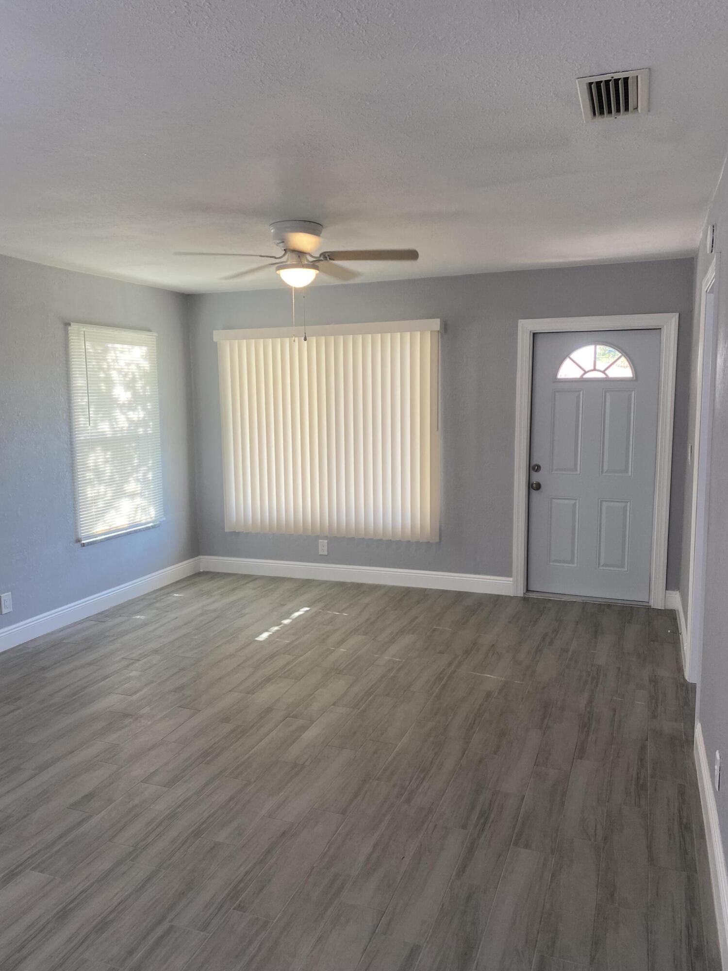 232 Northwest 9th Street Pompano Beach, FL 33060 - Photo 37 of 46 an empty room with wooden floor and windows