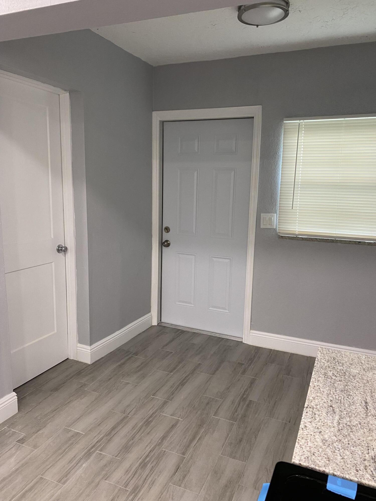 232 Northwest 9th Street Pompano Beach, FL 33060 - Photo 40 of 46 a view of an empty room with wooden floor and a window