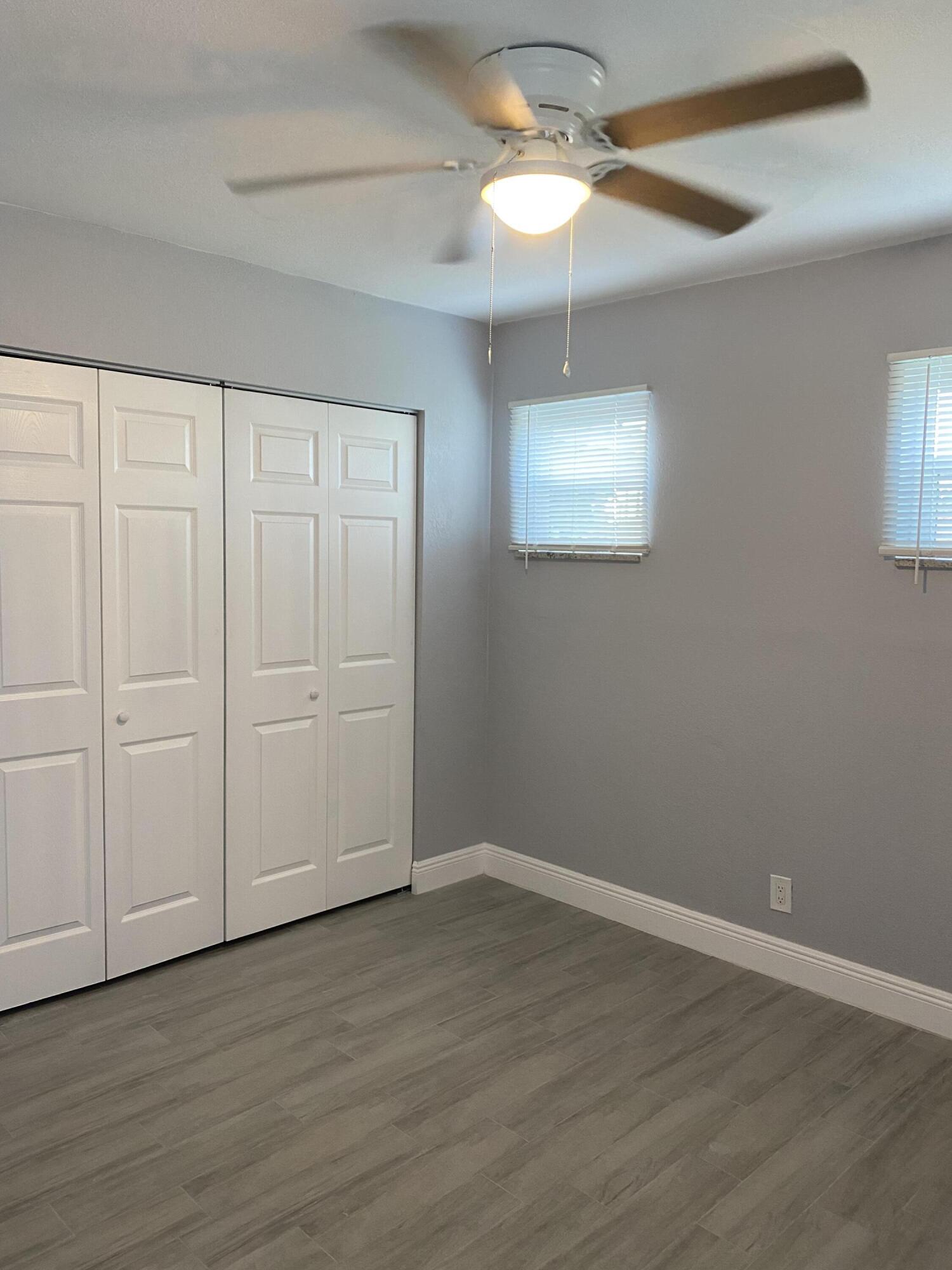 232 Northwest 9th Street Pompano Beach, FL 33060 - Photo 9 of 46 wooden floor in an empty room with a window