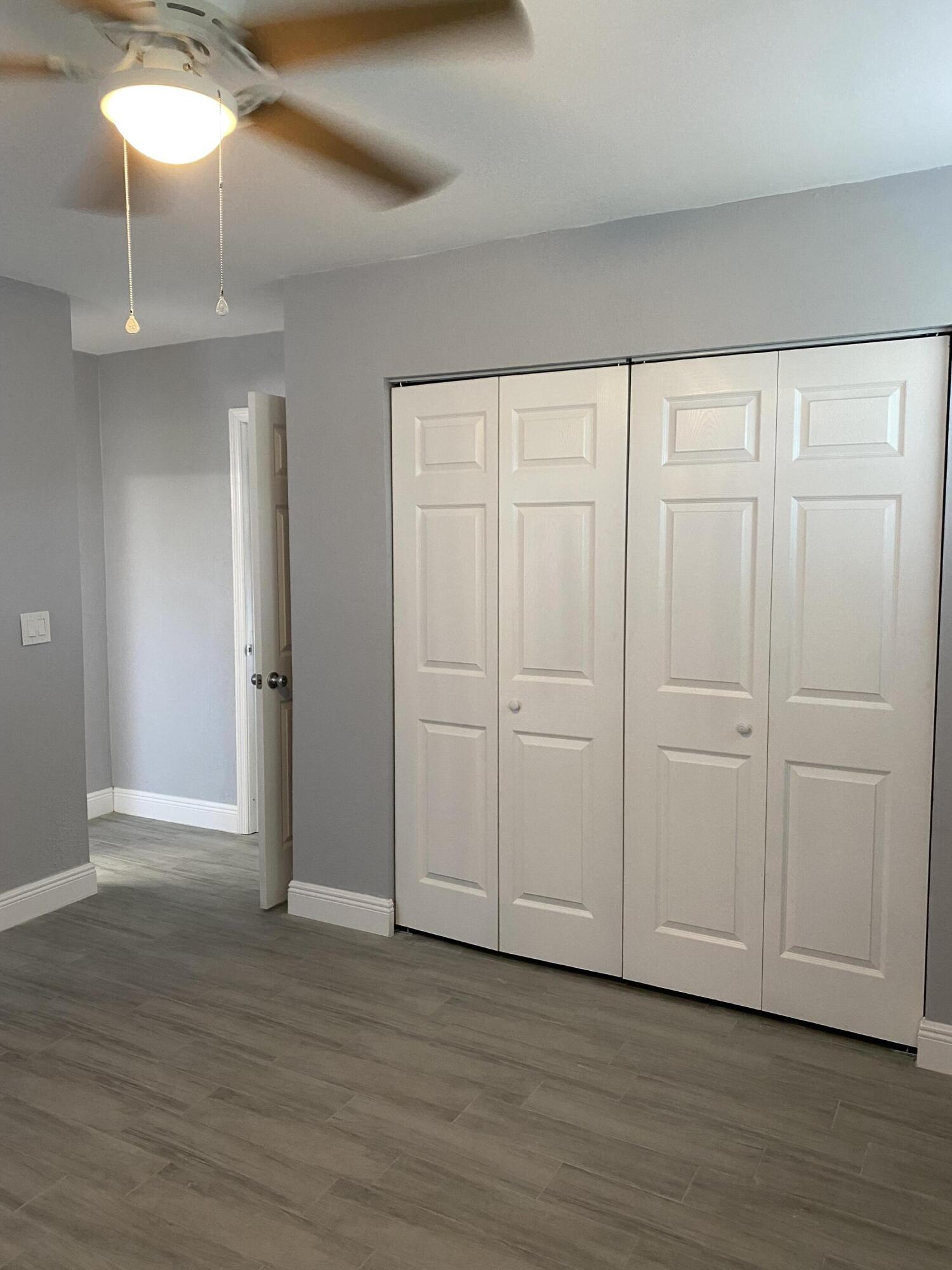 232 Northwest 9th Street Pompano Beach, FL 33060 - Photo 10 of 46 a view of an empty room with wooden floor