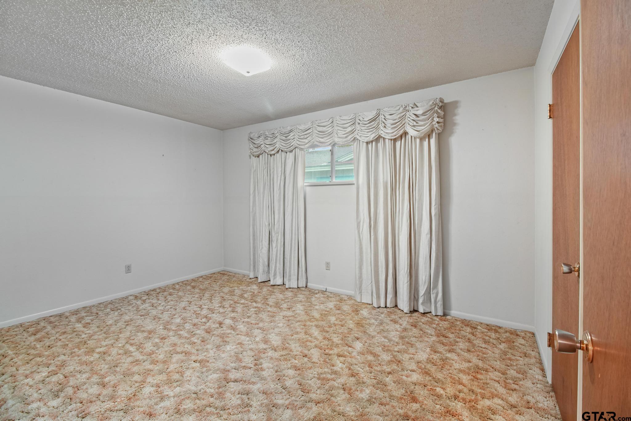 2742 Lisa Lane Tyler, TX 75701 - Photo 14 of 32 a view of a room with a wooden floor and cabinet