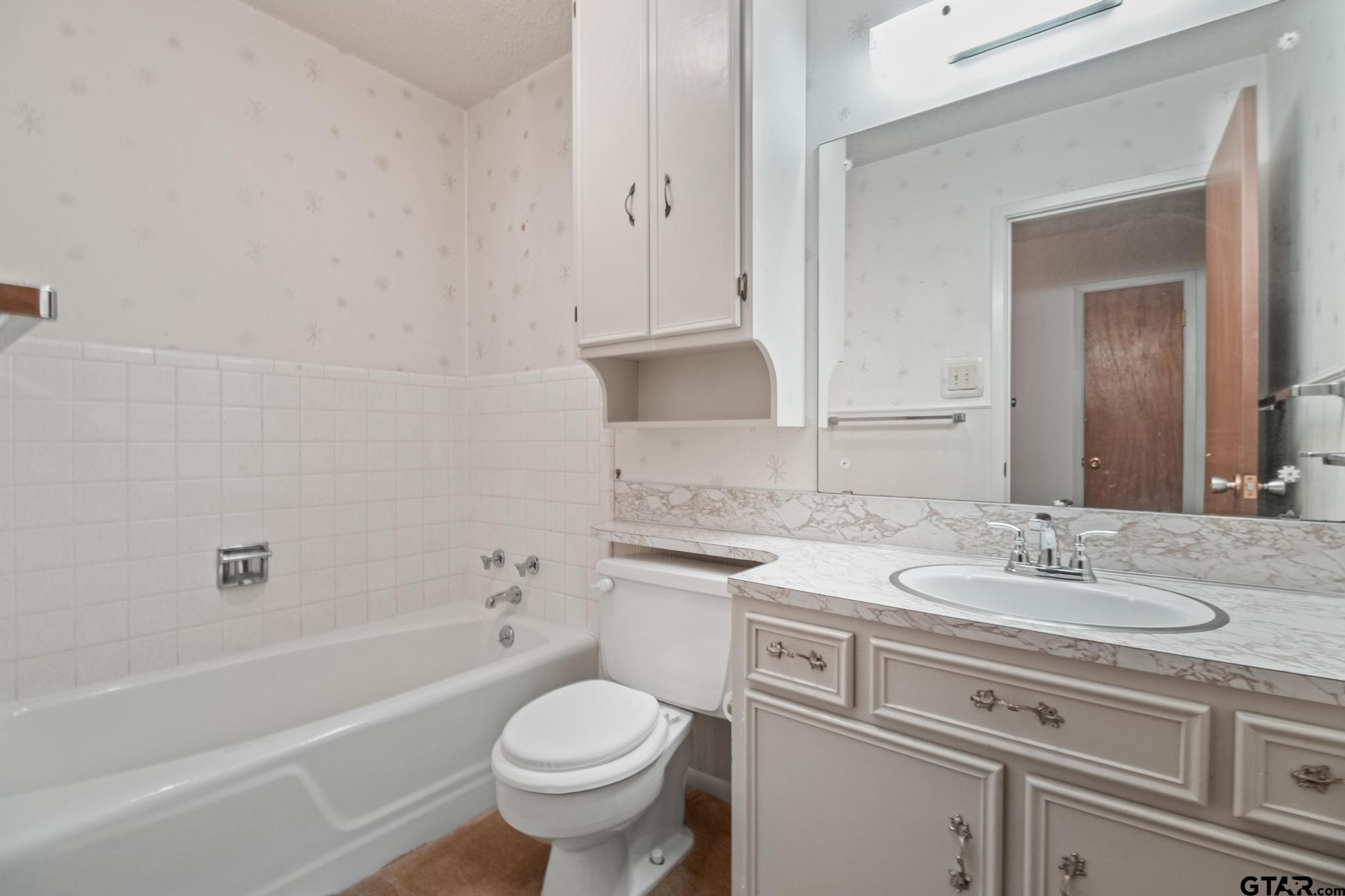 2742 Lisa Lane Tyler, TX 75701 - Photo 20 of 32 a bathroom with a sink toilet vanity and bathtub