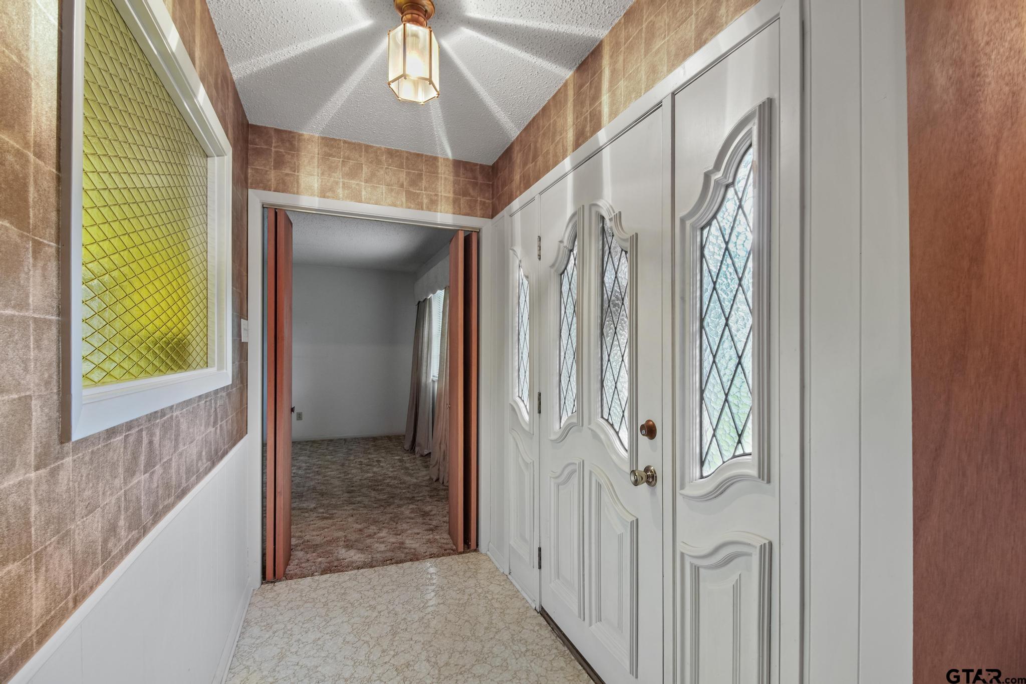 2742 Lisa Lane Tyler, TX 75701 - Photo 22 of 32 a view of a hallway with a door and windows