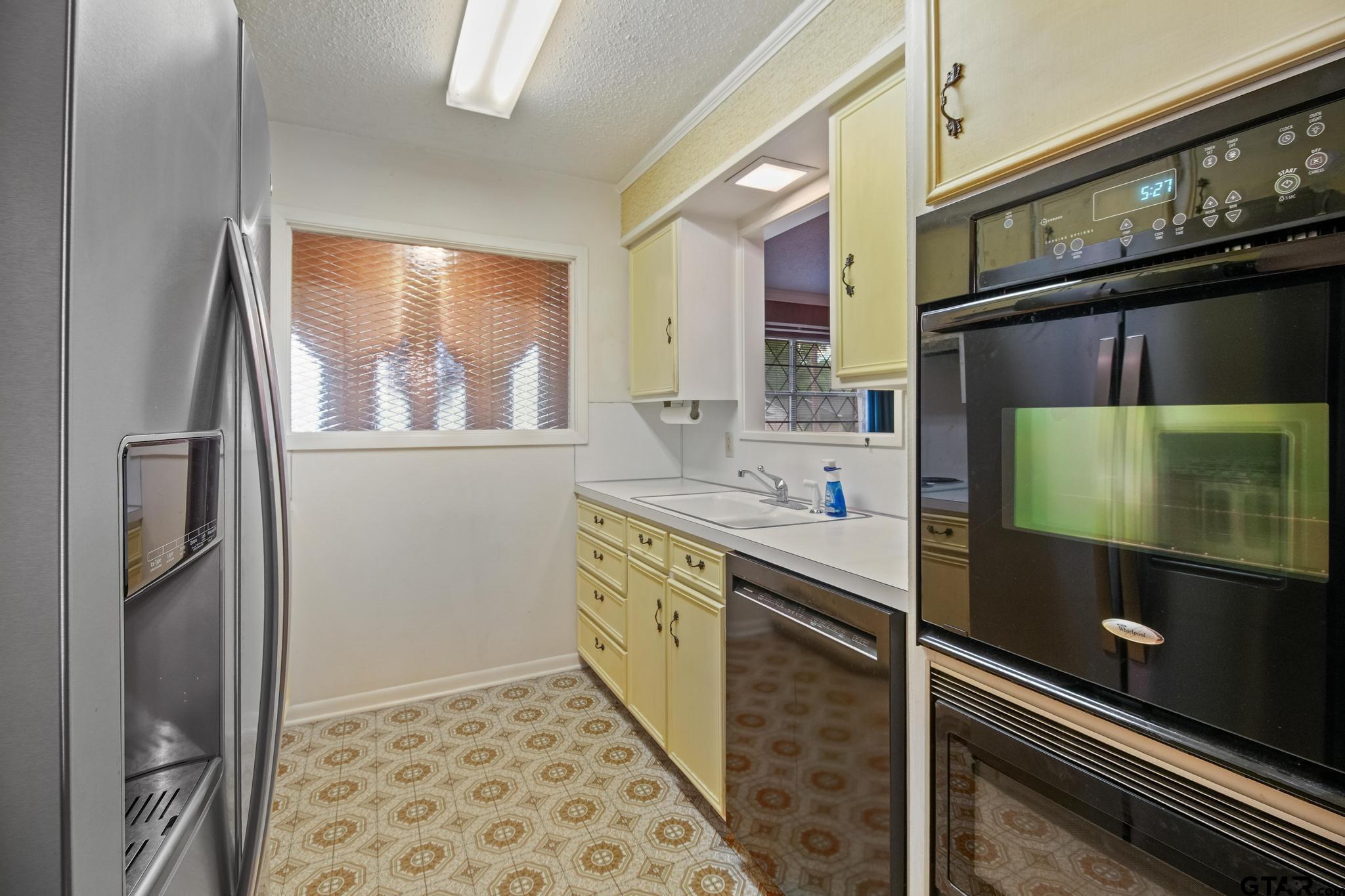 2742 Lisa Lane Tyler, TX 75701 - Photo 4 of 32 a kitchen with stainless steel appliances a sink and cabinets