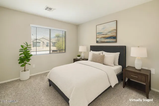 an empty room with a chandelier fan and windows