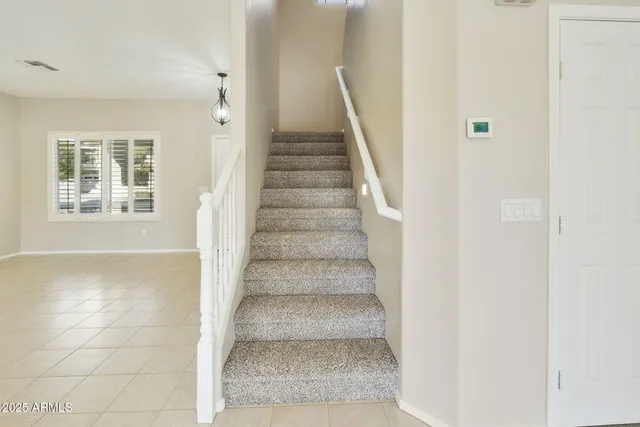 a view of a patio with table and chairs under a large tree