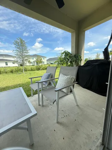 a view of a patio with a table and chairs