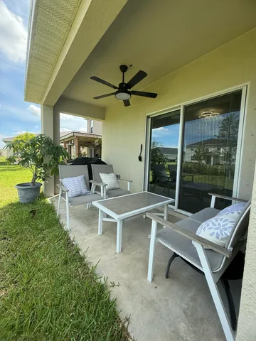 a view of a patio with chairs and a table