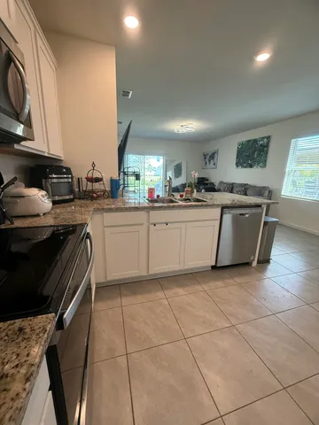a kitchen with stainless steel appliances granite countertop a sink and cabinets