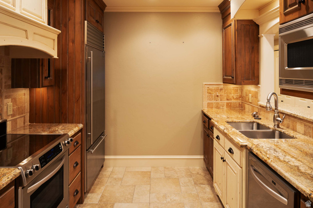 875 South 1250th Street East Mapleton, UT 84664 - Photo 42 of 54 Galley-style kitchen featuring wood-finish cabinetry, stainless steel appliances, granite countertops, and stone tile flooring