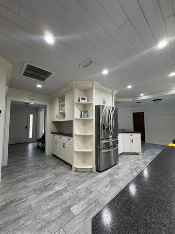a kitchen with a refrigerator and a sink