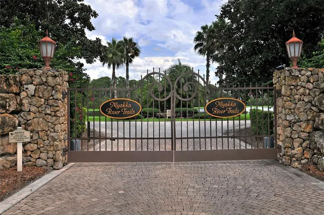 a view of a brick wall with a tree in the background