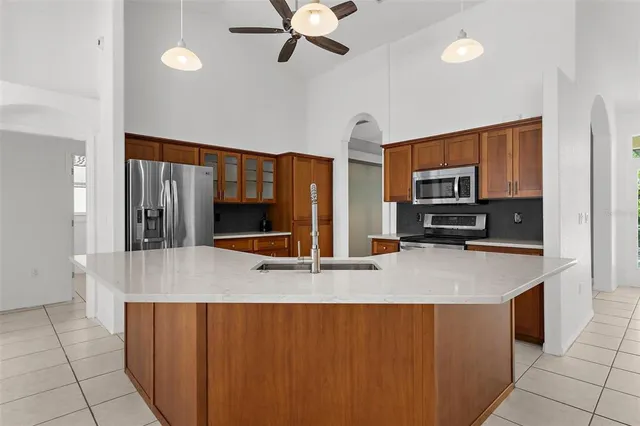 a view of a dining room with furniture a chandelier and wooden floor