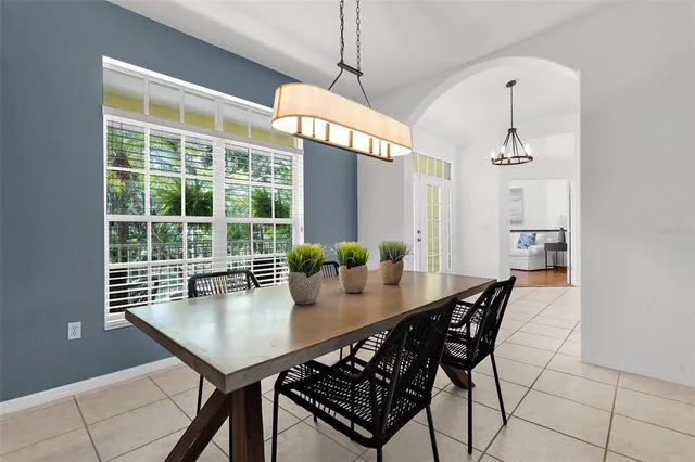 a kitchen with a sink and chairs