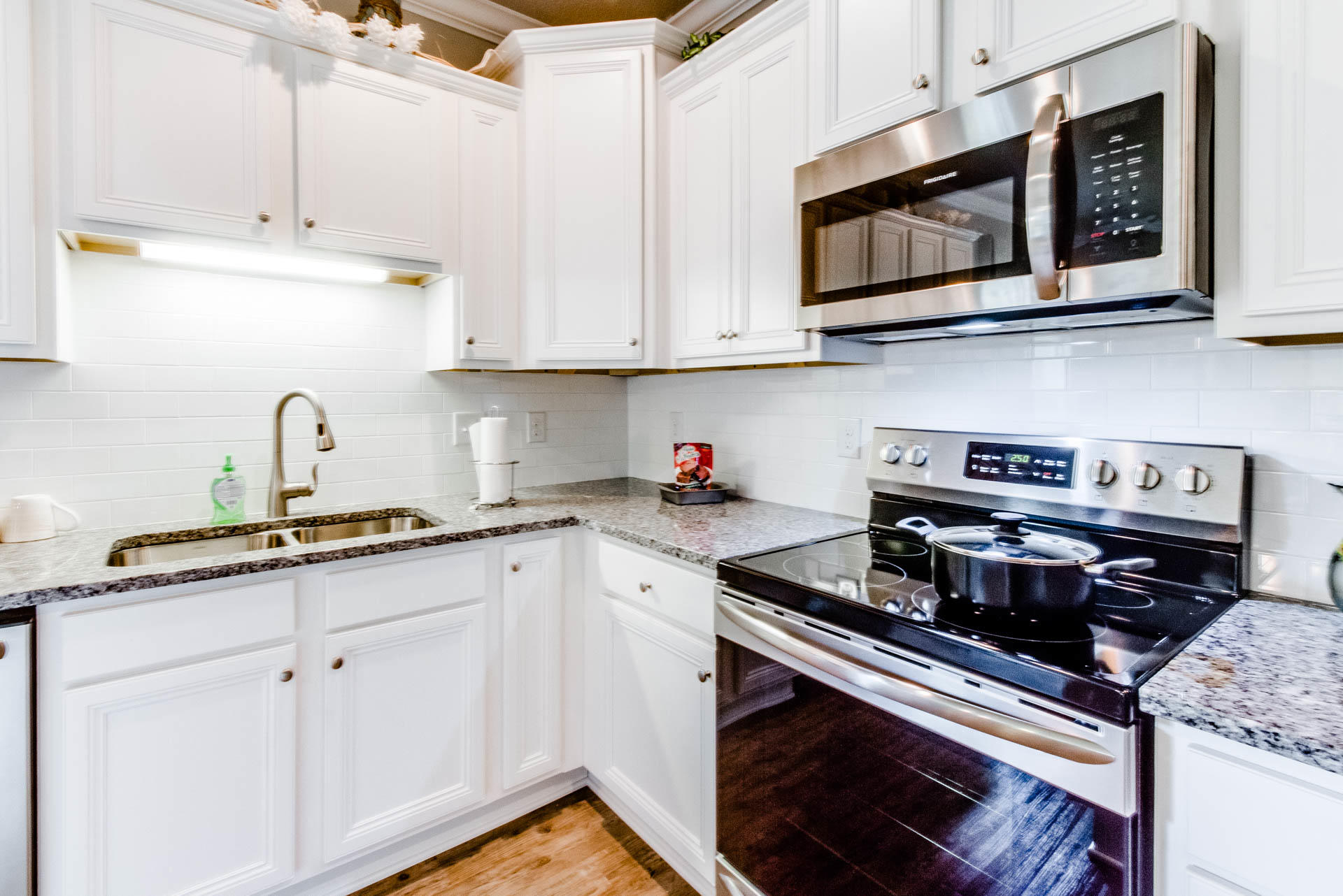 219 Southern Pnes Road Santa Rosa Beach, FL 32459 - Photo 10 of 28 a kitchen with stainless steel appliances granite countertop a sink and a stove