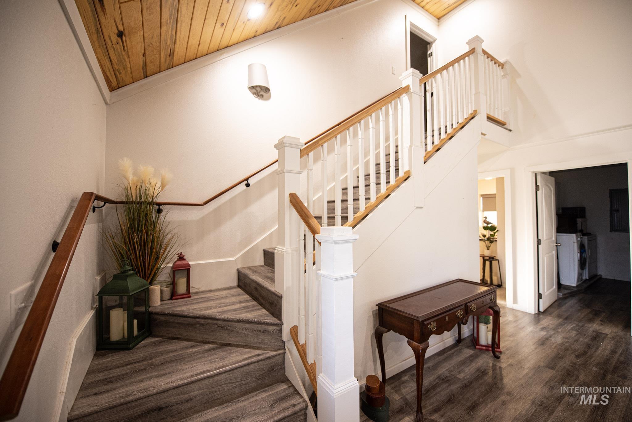 41167 Little Canyon Road Peck, ID 83545 - Photo 4 of 8 Vaulted wood-paneled ceiling, white newel posts and balusters, wood handrails, and wood-finish flooring