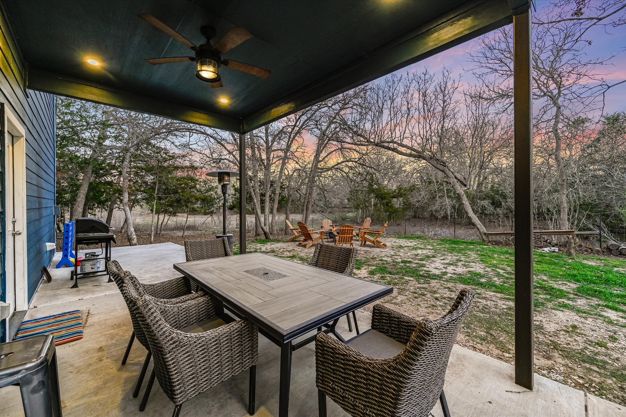 8400 Taylorsville Road Dale, TX 78616 - Photo 22 of 38 Patio terrace at dusk with a patio, outdoor dining space, a ceiling fan, and a grill