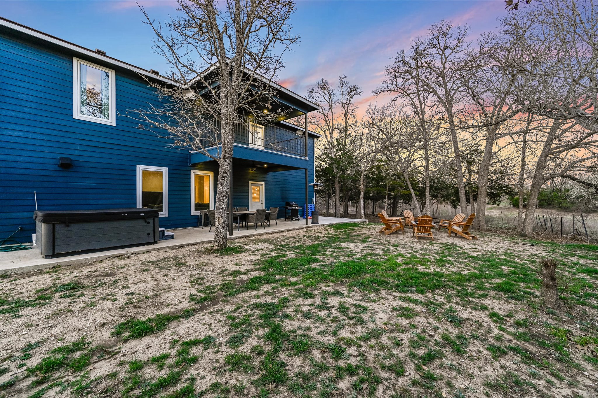 8400 Taylorsville Road Dale, TX 78616 - Photo 23 of 38 Rear view of property featuring a balcony, a patio, a hot tub, and an outdoor fire pit