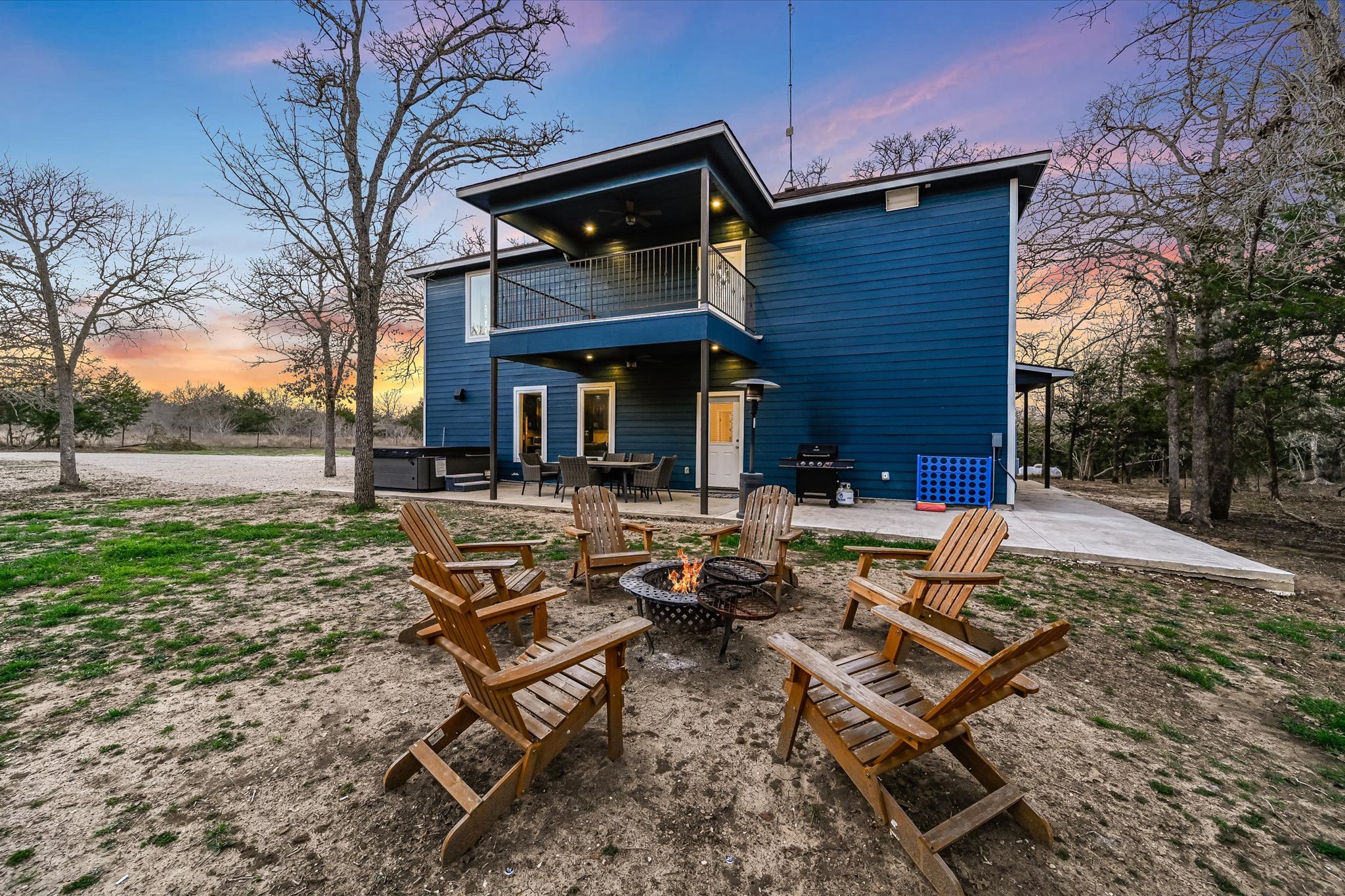 8400 Taylorsville Road Dale, TX 78616 - Photo 25 of 38 Back of house with a patio area, a balcony, and an outdoor fire pit