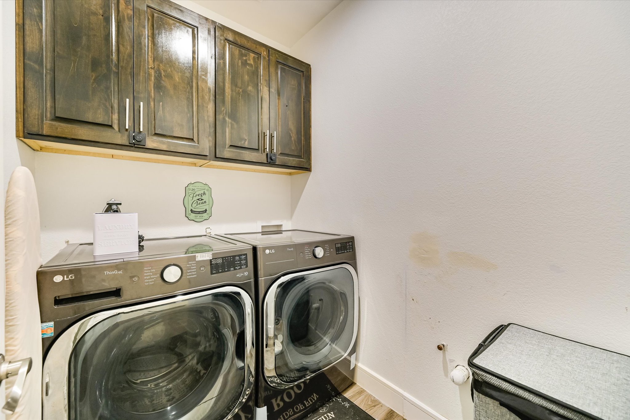 8400 Taylorsville Road Dale, TX 78616 - Photo 9 of 38 Laundry room featuring cabinet space, washing machine and clothes dryer, and light wood-style flooring