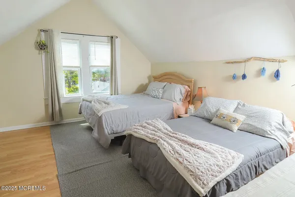 a bedroom with two beds and a window