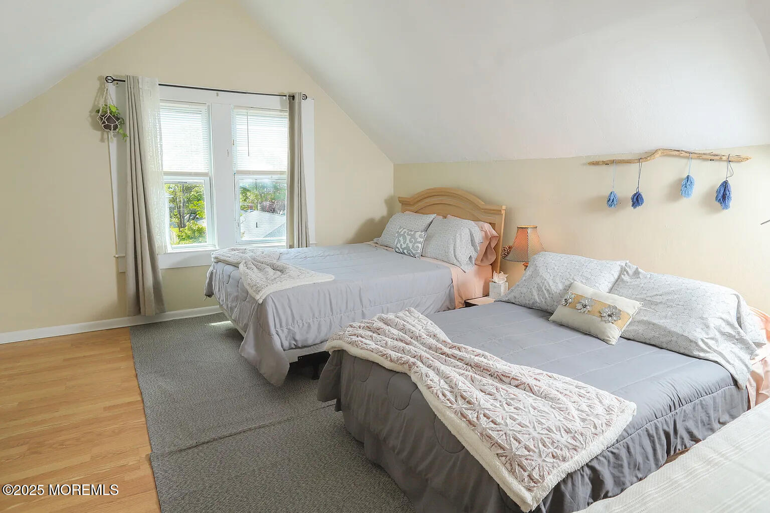 a bedroom with two beds and a window