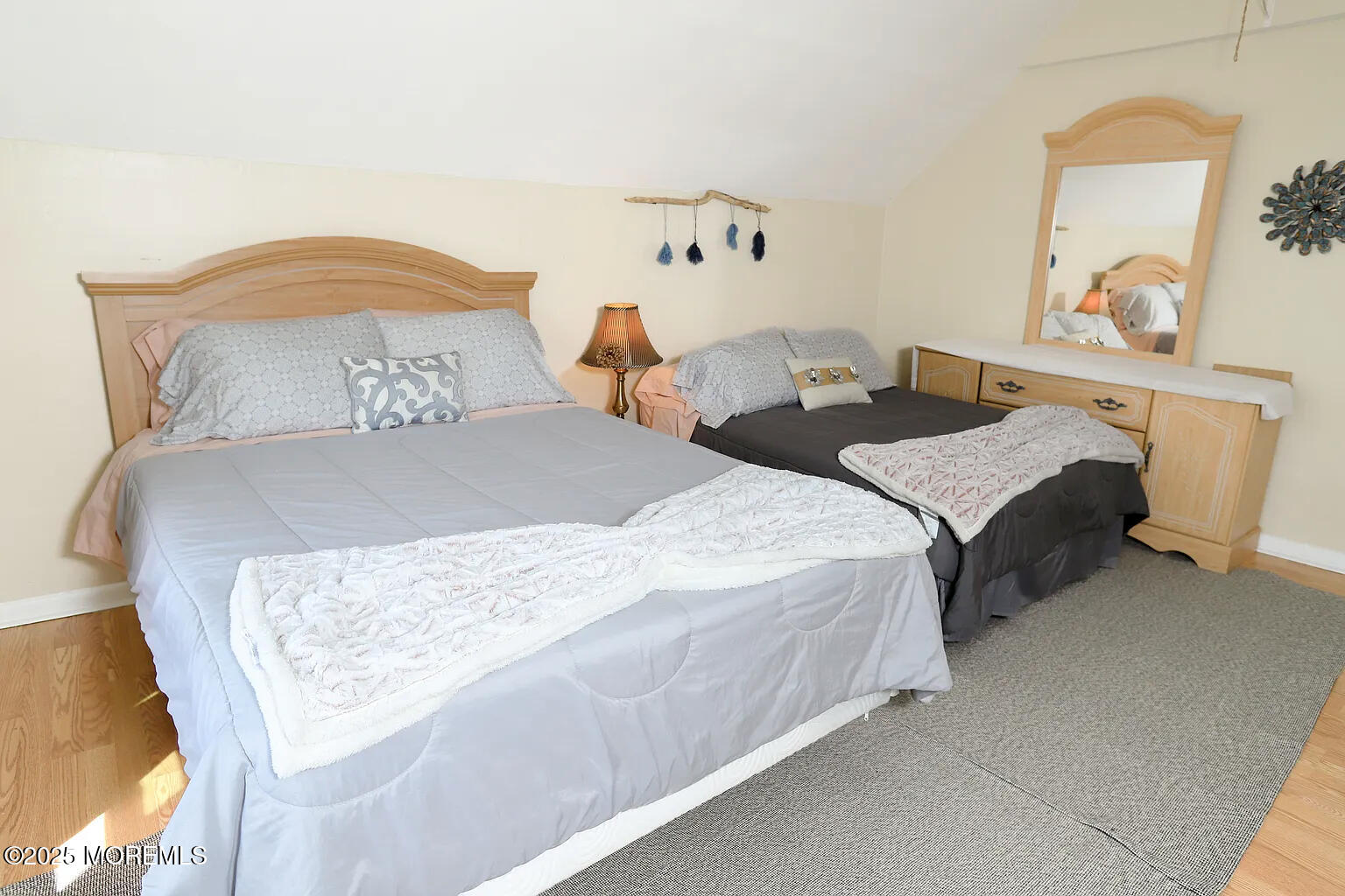 49 2nd Avenue, Unit 3 Long Branch, NJ 07740 - Photo 3 of 11 a bedroom with a bed and dresser