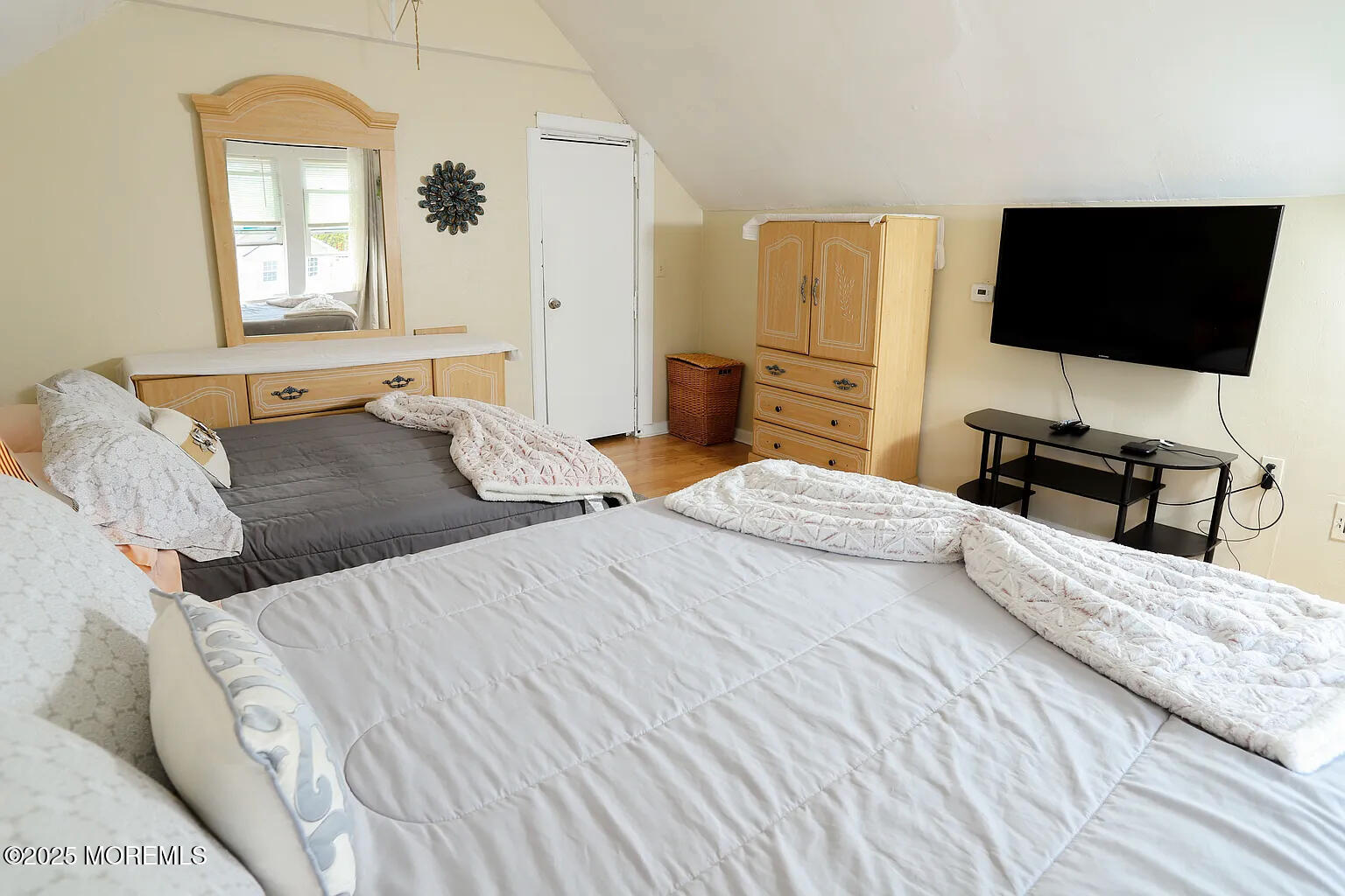 49 2nd Avenue, Unit 3 Long Branch, NJ 07740 - Photo 4 of 11 a bedroom with a bed and a flat screen tv