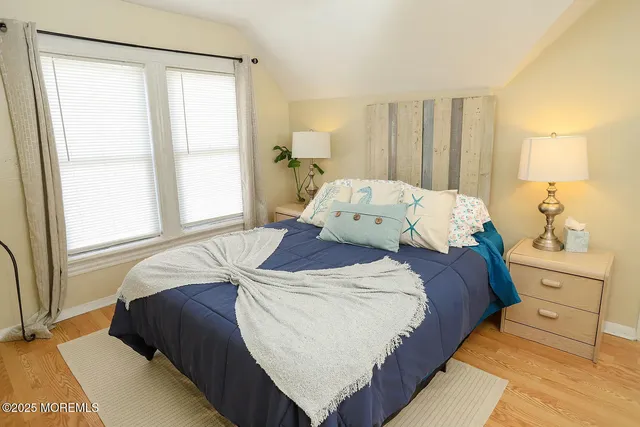 a bed sitting in a bedroom next to a window