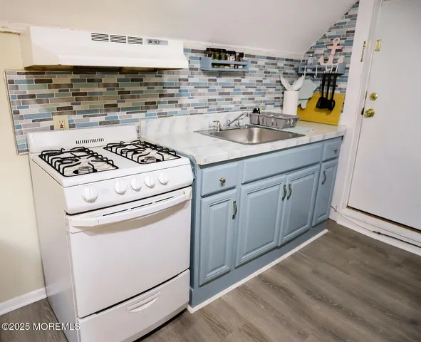 a kitchen with a stove and a sink