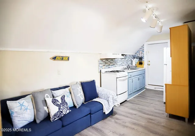 a view of kitchen with furniture and wooden floor