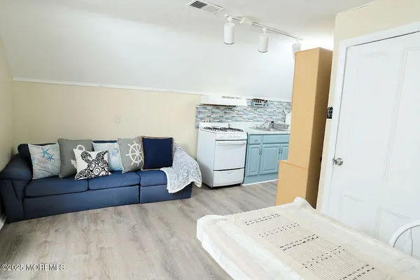 a living room with a couch and a refrigerator