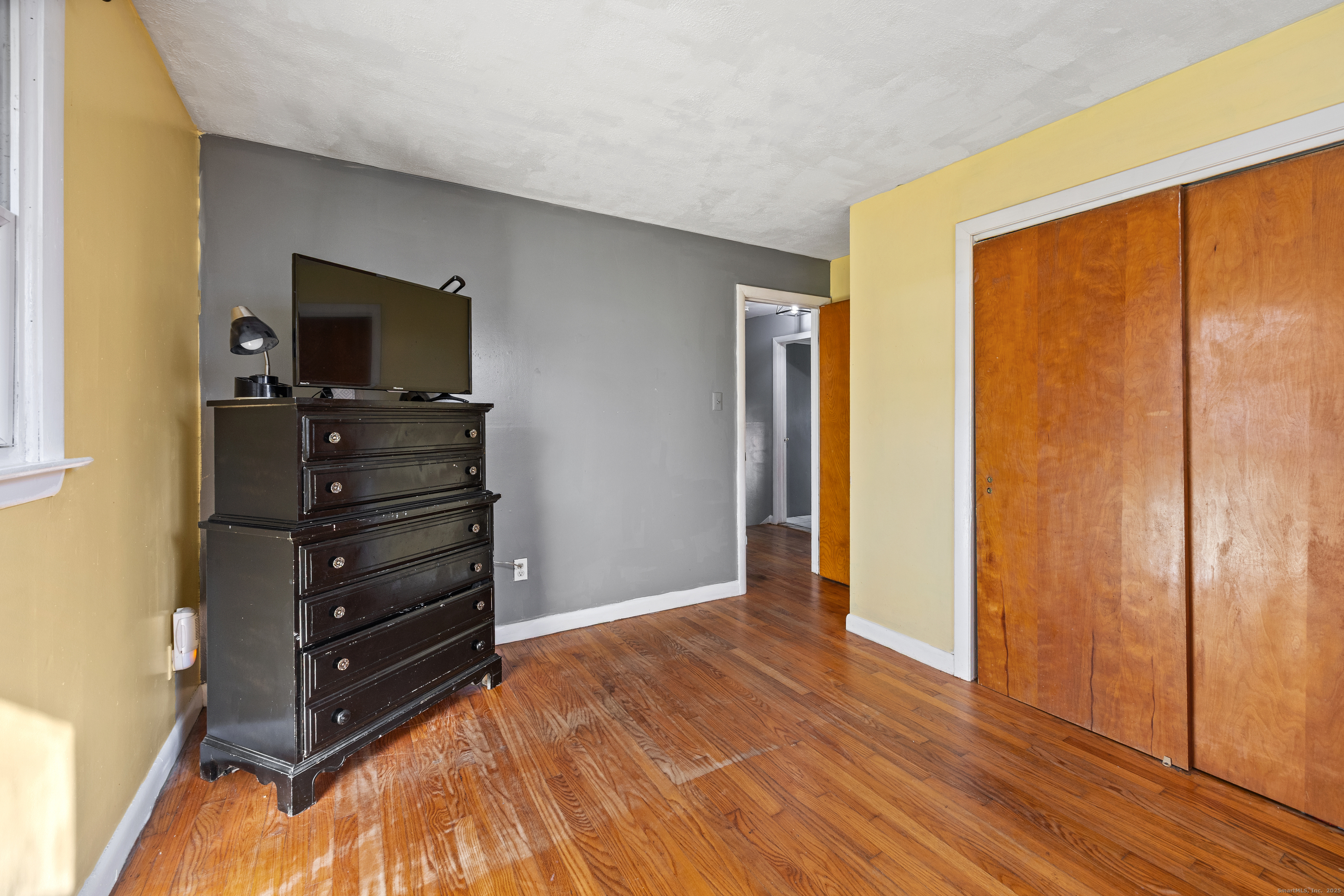 122 North Airline Road Wallingford, CT 06492 - Photo 20 of 33 a room with a dresser and a flat screen tv