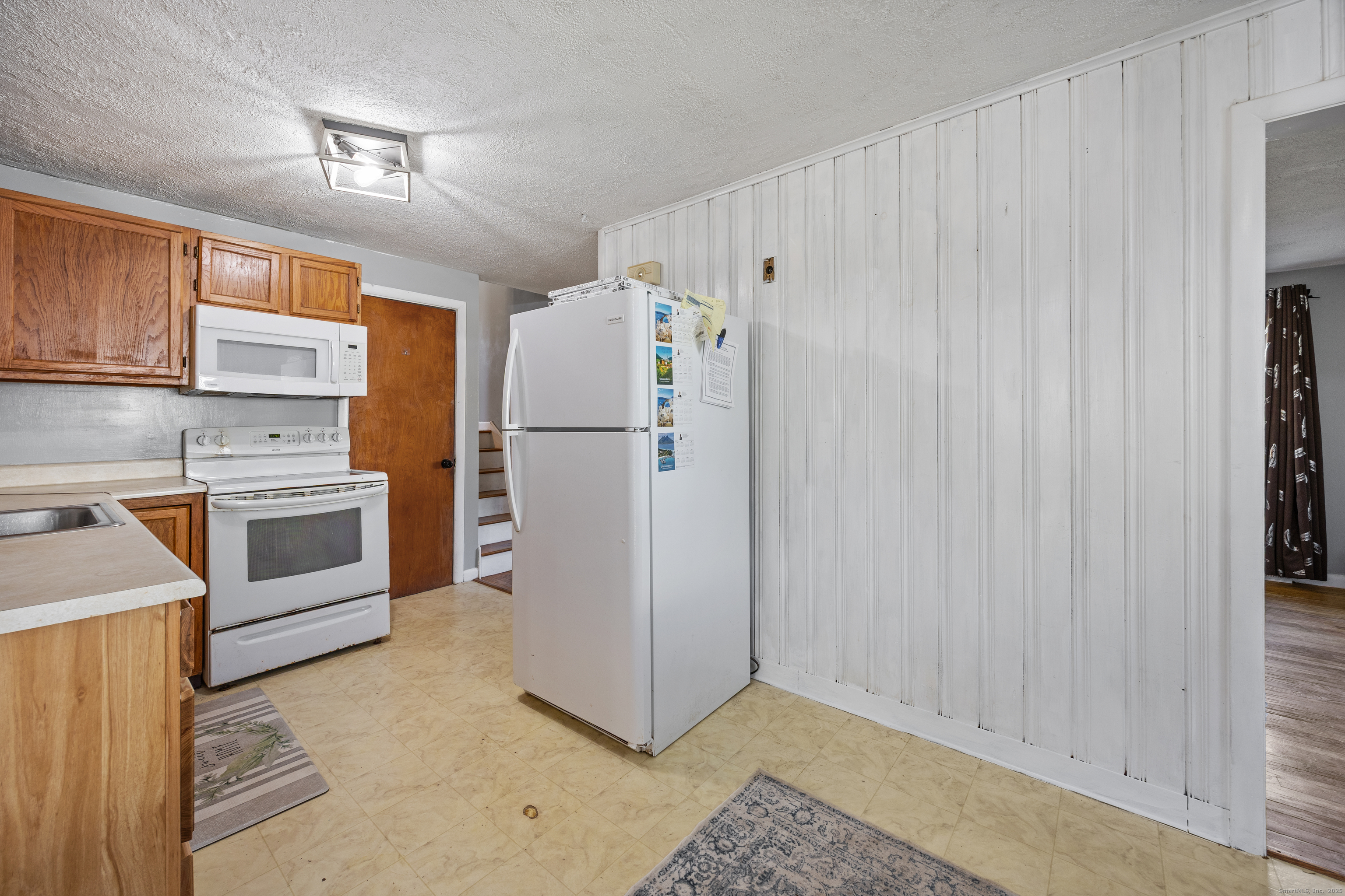 122 North Airline Road Wallingford, CT 06492 - Photo 9 of 33 a kitchen with white cabinets and white appliances