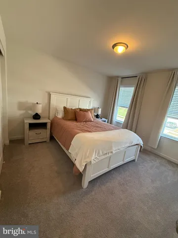 a bedroom with a bed and a night stand