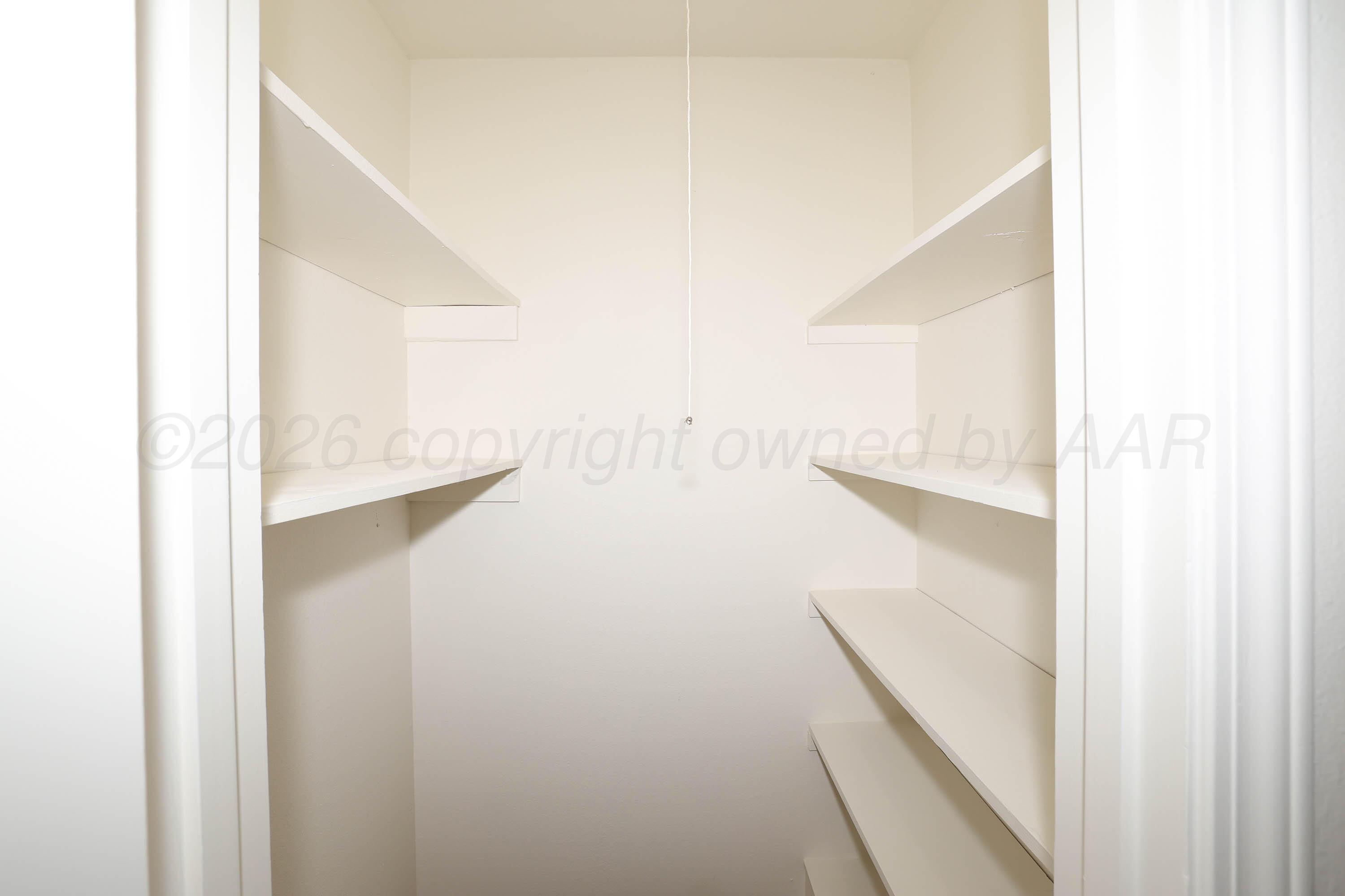 4415 Kingston Road Amarillo, TX 79109 - Photo 25 of 28 a view of walk in closet with empty racks